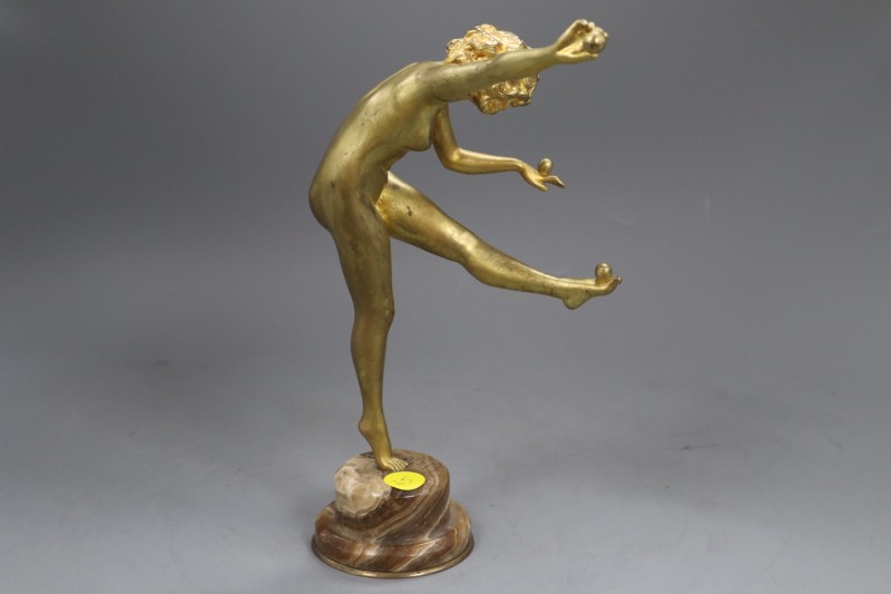 An Art Deco style bronze figure of a nude female juggler, signed to the base, C J R Colinet, overall 25cm